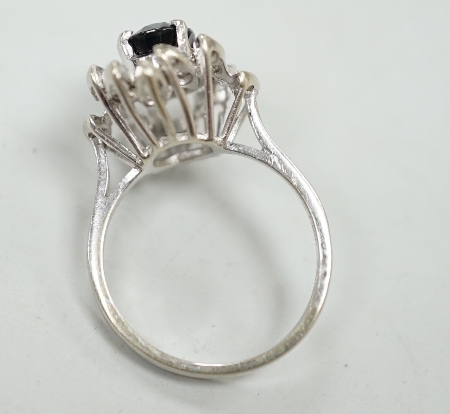 A modern 750 white metal, sapphire and diamond cluster set dress ring (two diamonds missing), size N, gross weight 5.2 grams.